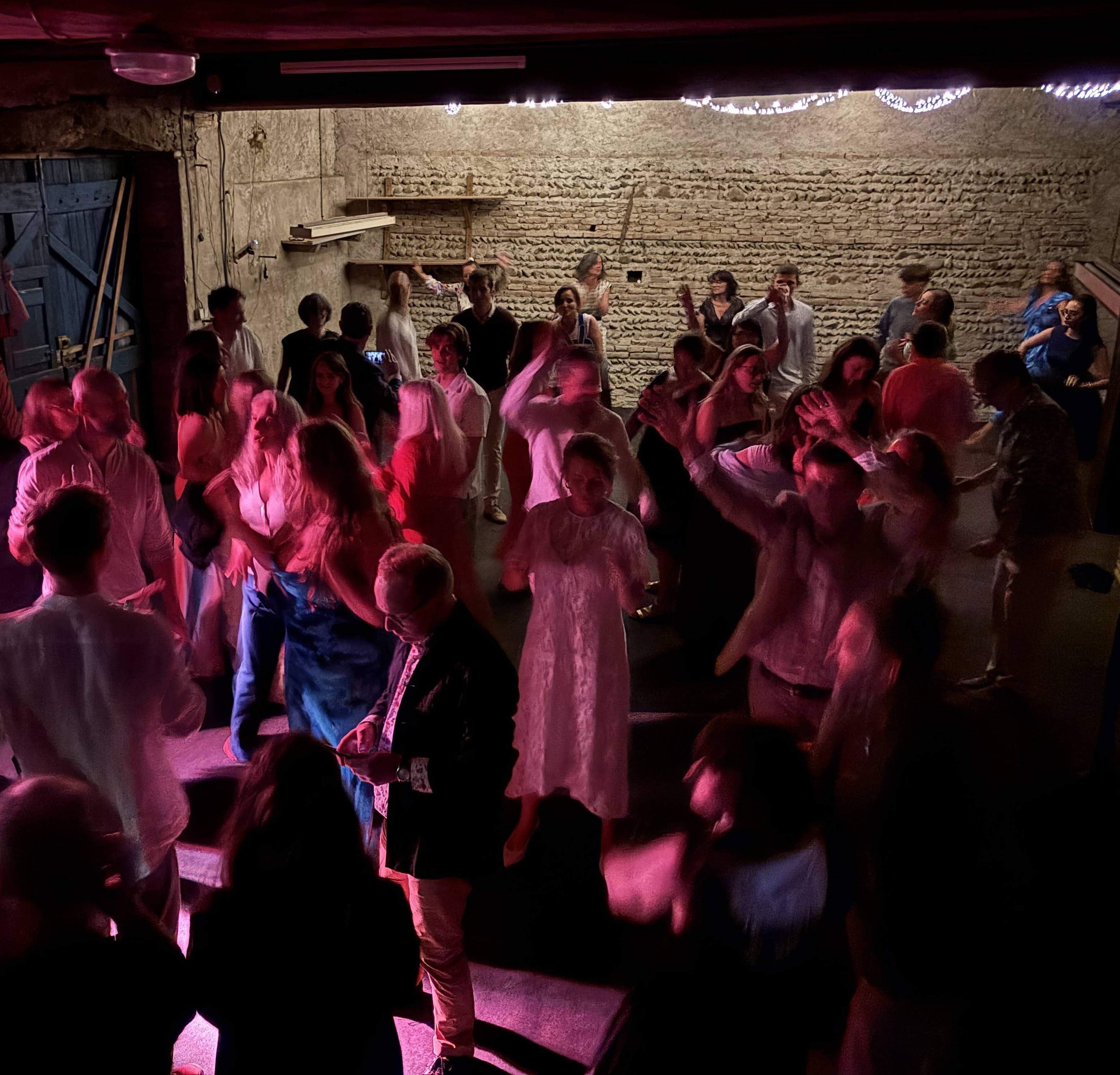 Wedding guests dancing in barn with Howard Whiddett DJ